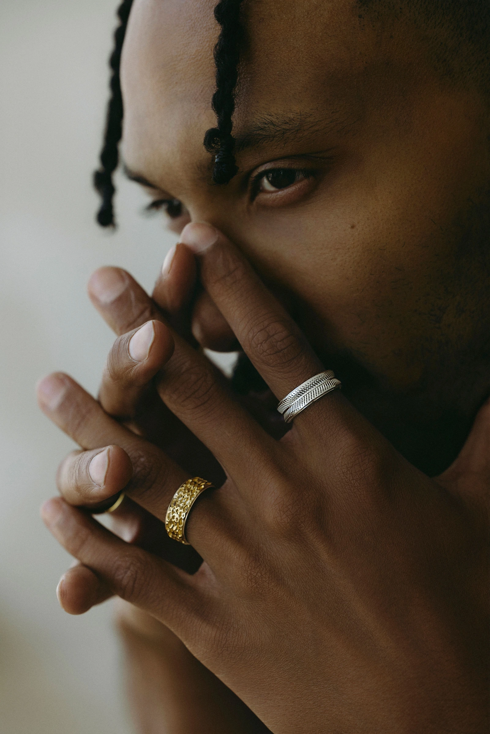 Model wearing rings with a hand held near the face